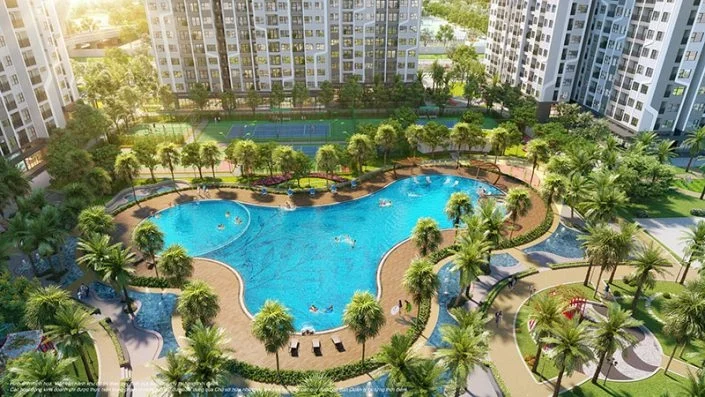 Toàn cảnh bể bơi nội khu hình lá sen với nhiều người đang bơi và các tòa căn hộ xung quanh