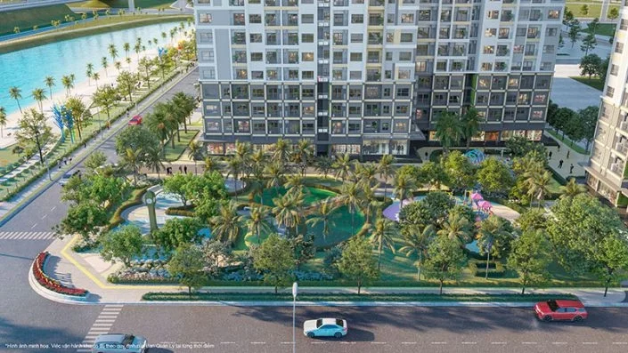 Cảnh quan sân vườn nội khu với cây xanh, tháp đồng hồ, khu vui chơi trẻ em và mặt tiền tòa nhà căn hộ
