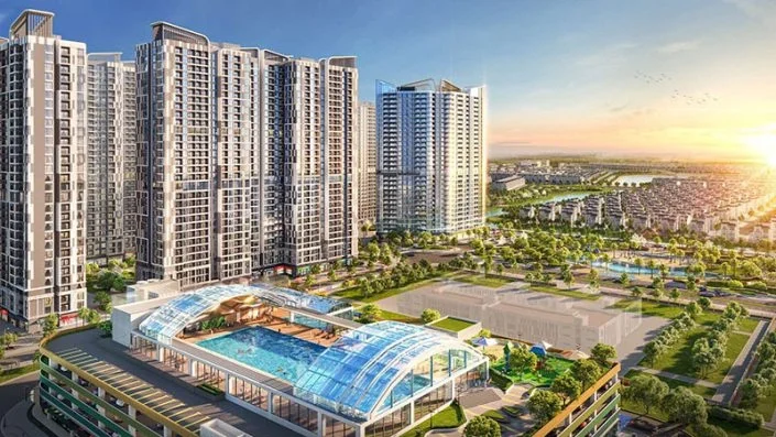 Toàn cảnh khu đô thị với các tòa chung cư cao tầng, bể bơi mái kính và khu dân cư biệt thự phía xa lúc hoàng hôn.