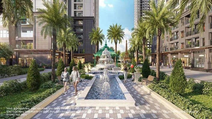 Đường dạo bộ với đài phun nước, hàng cọ xanh và các cửa hàng thương mại