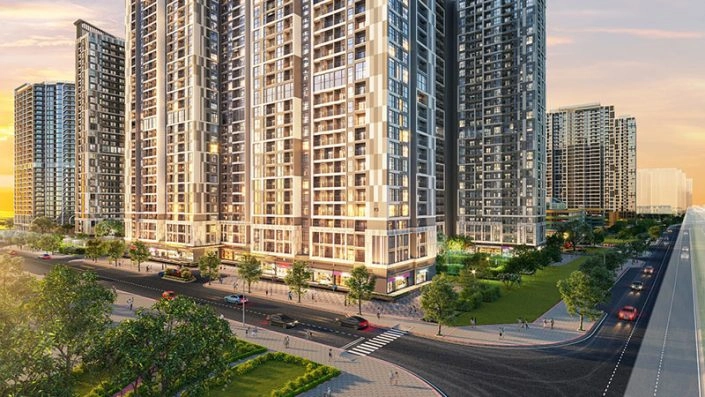 Toàn cảnh các tòa căn hộ cao tầng hiện đại với đường phố và cây xanh xung quanh vào buổi hoàng hôn