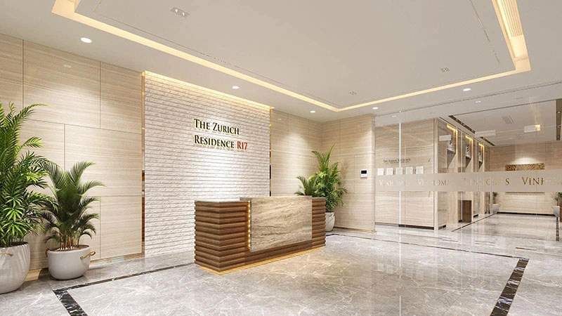 Sảnh lễ tân sang trọng của The Zurich Residence R17 với quầy tiếp tân ốp gỗ đá, tường gạch và cây xanh trang trí